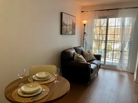 Sitting and dining area with a sofa, round table and balcony door