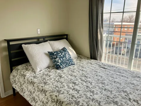 Bedroom with a double bed beside a large window