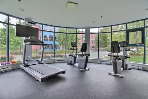 Exercise room with treadmills, stationary machines and windows