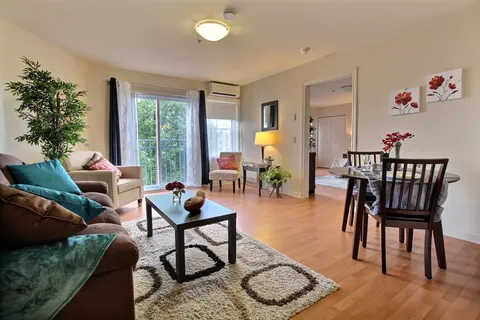 Sitting area with a sofa, armchairs, a coffee table and dining table