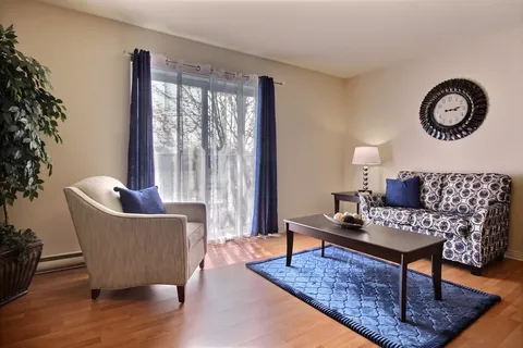 Sitting area with a patterned sofa, armchair and coffee table